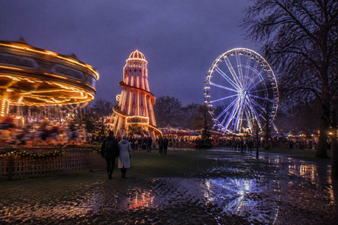 Winter Wonderland rides and attractions at dusk with festive lights