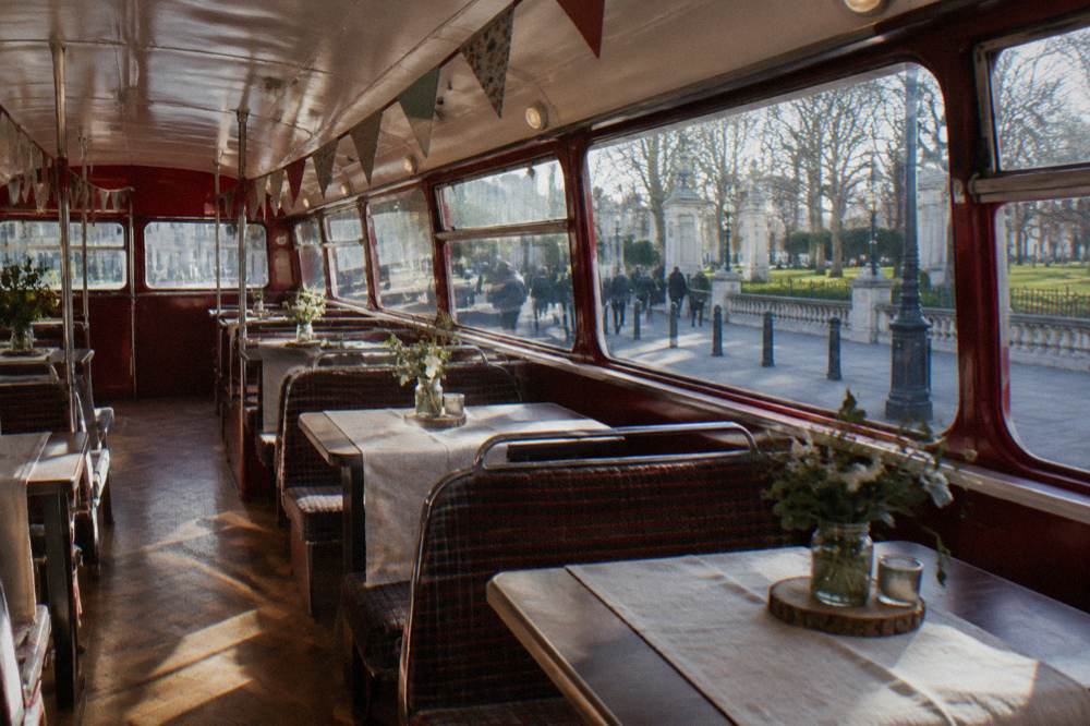 Retro double decker bus interior with laid tea tables and bunting