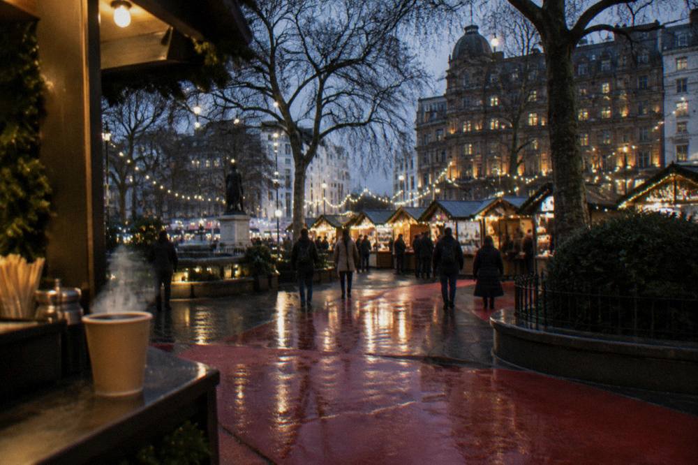 Festive market stalls glowing under string lights in the evening