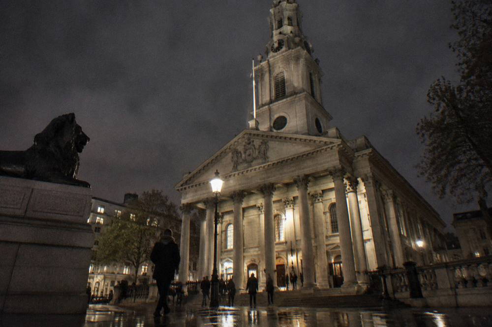 Stone cathedral facade lit against a dark winter sky