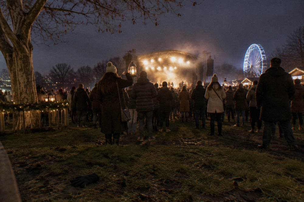 Open-air stage glowing with warm lights in a park after dark