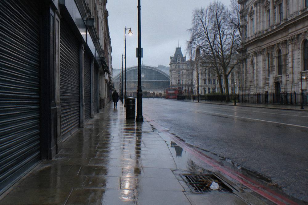 An empty London street on a quiet winter morning with a red bus in the distance