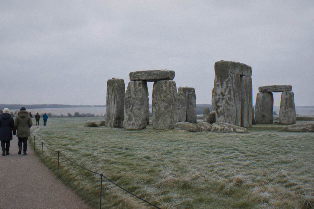 Stonehenge standing stones under a pale winter sky