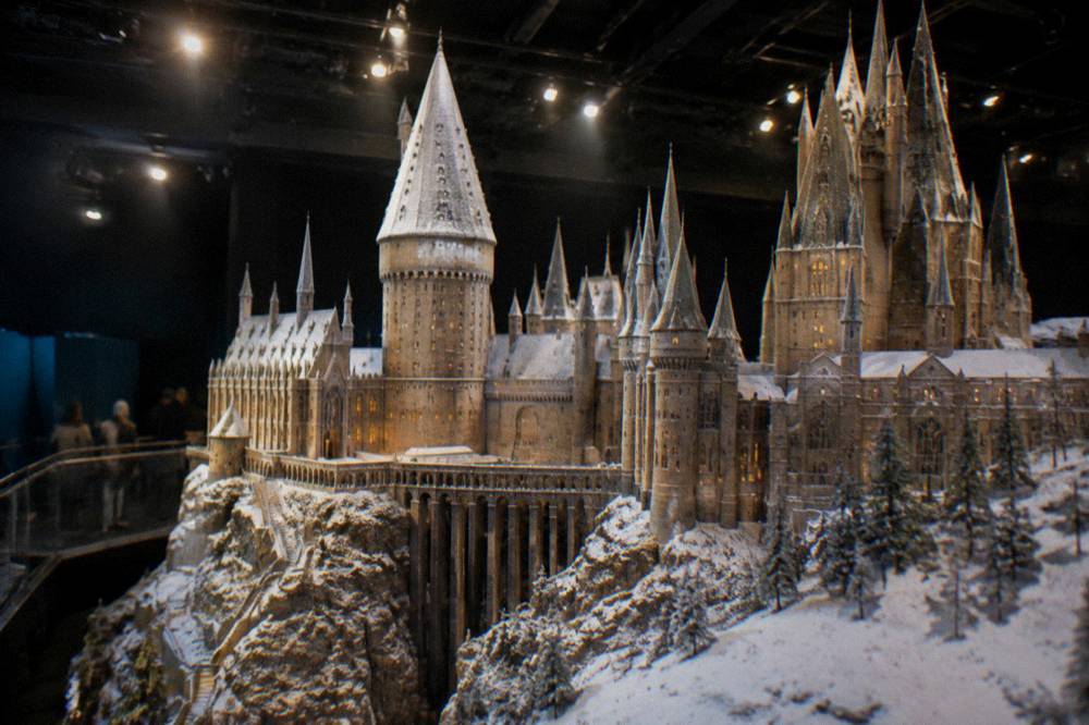 A snowy castle model with miniature towers under studio lighting