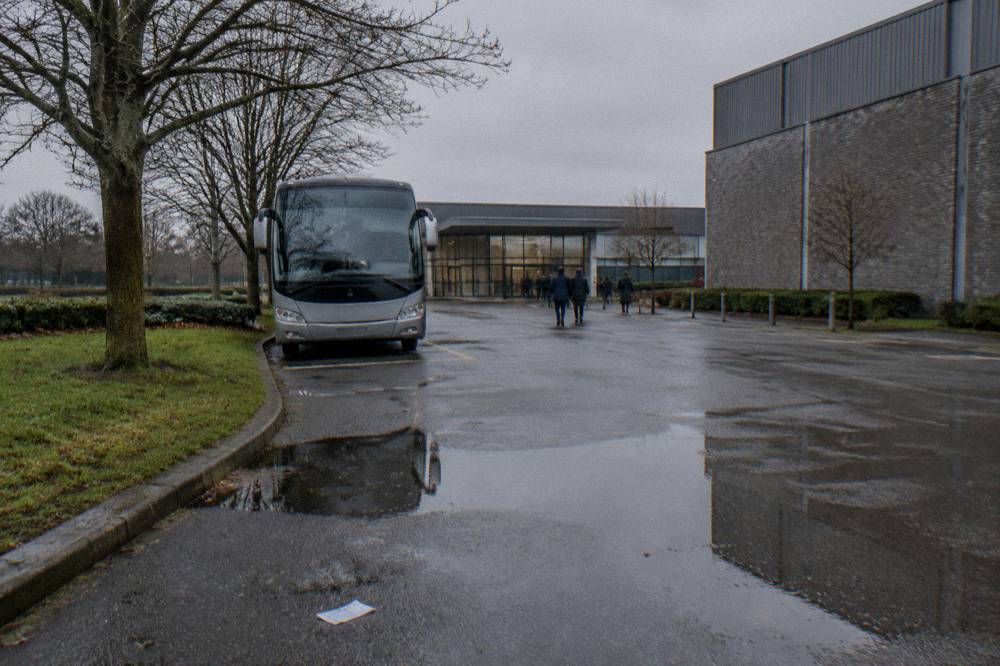 Coach parked at a studio entrance with winter trees in the background