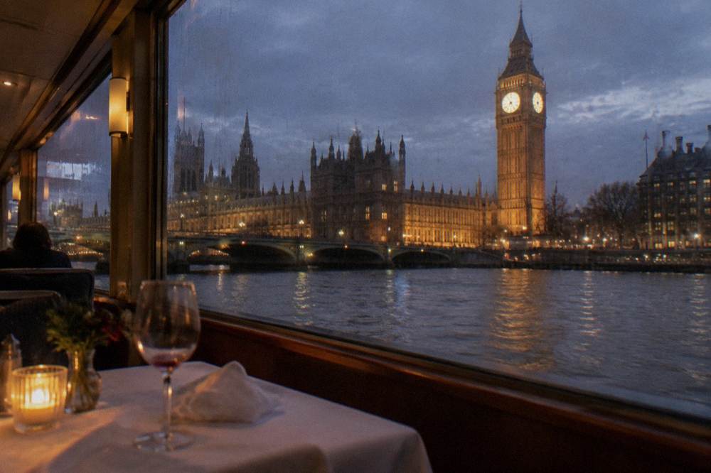 A table set for a festive dinner aboard a river cruise boat with candles and decorations