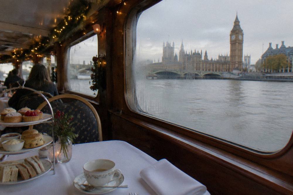 A festively decorated cruise boat cabin interior with set dining tables